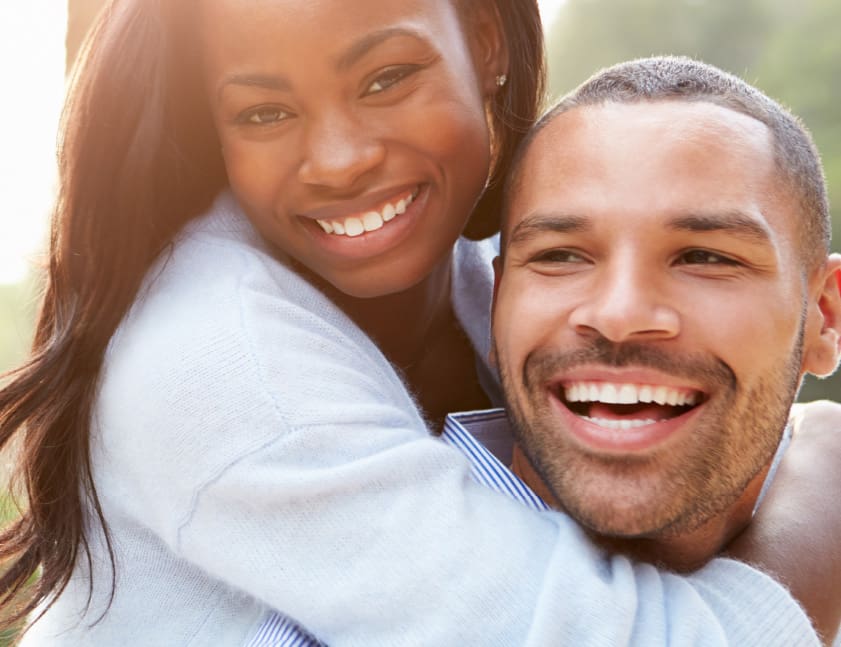 patients Smiling man and woman, symbolizing the joy and confidence that comes from a healthy smile, encouraging new patients to refer friends and family.